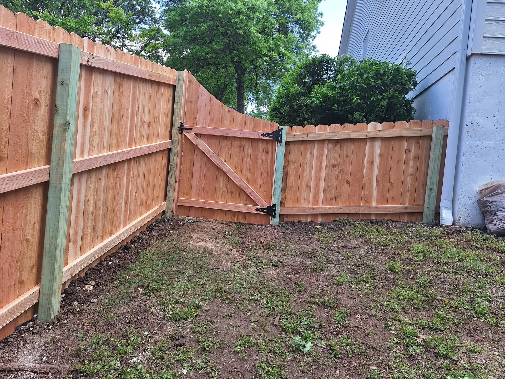 Curved cedar gate wood fence Kansas City by Pride Fence KC