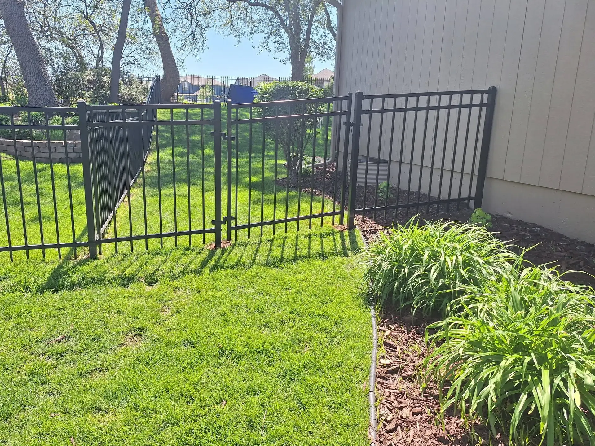 Sloped ornamental steel fence Kansas City by Pride Fence KC