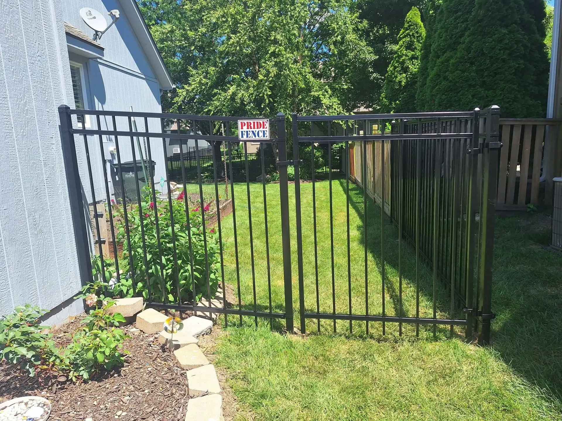 Ornamental steel gate with Pride Fence KC logo Kansas City