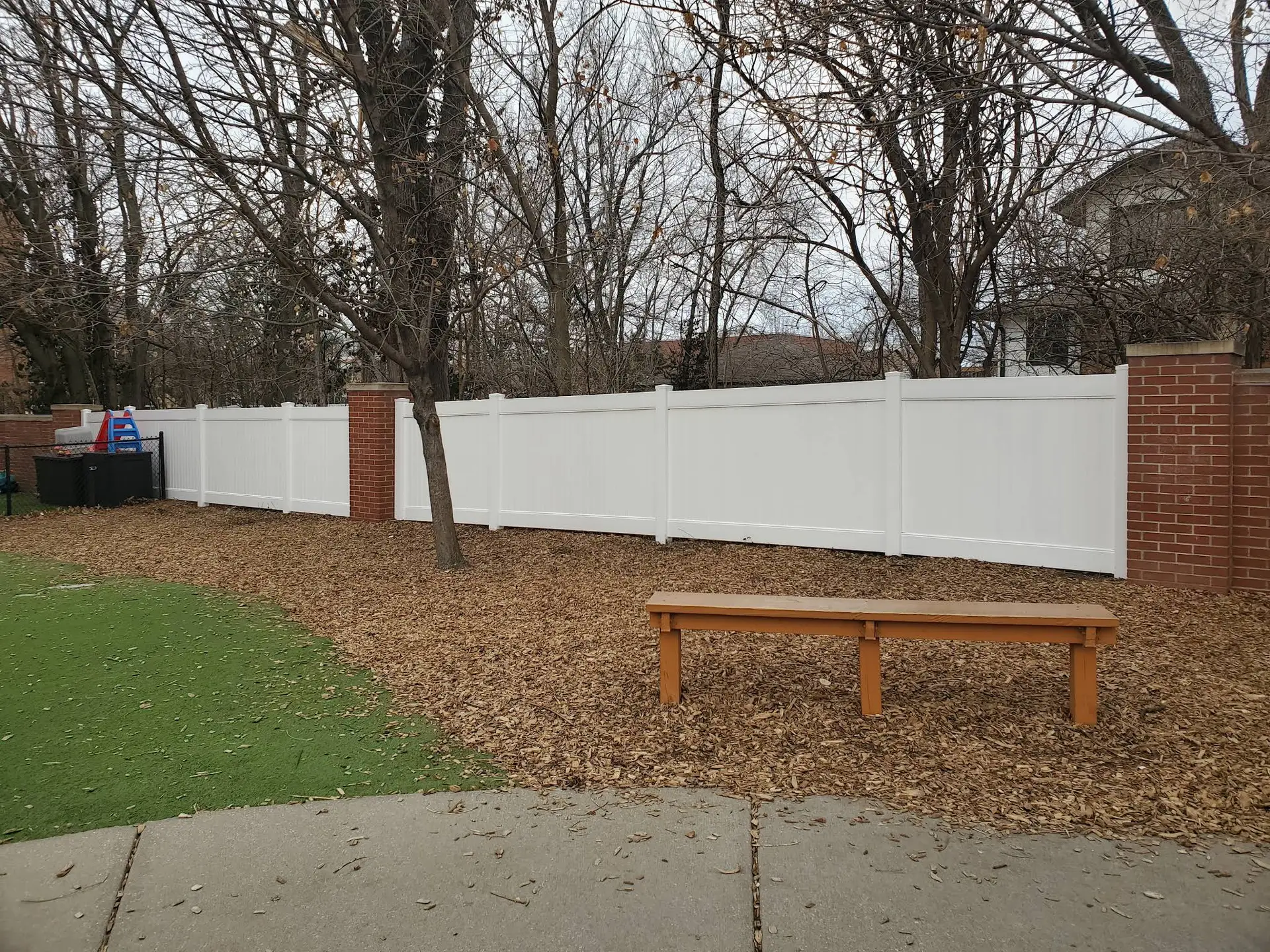 Vinyl fence with brick posts Kansas City by Pride Fence KC