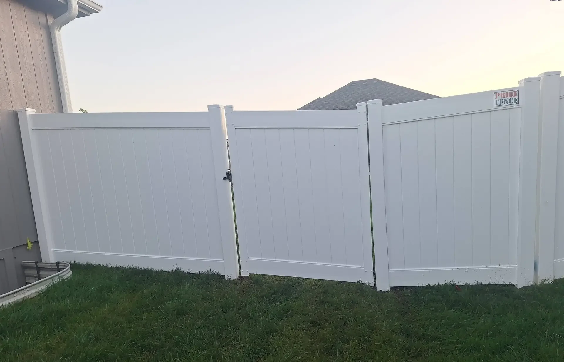 White vinyl fence suburban home